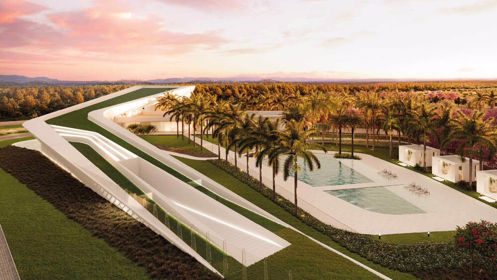 Vista aérea de arquitetura moderna com palmeiras e piscina.