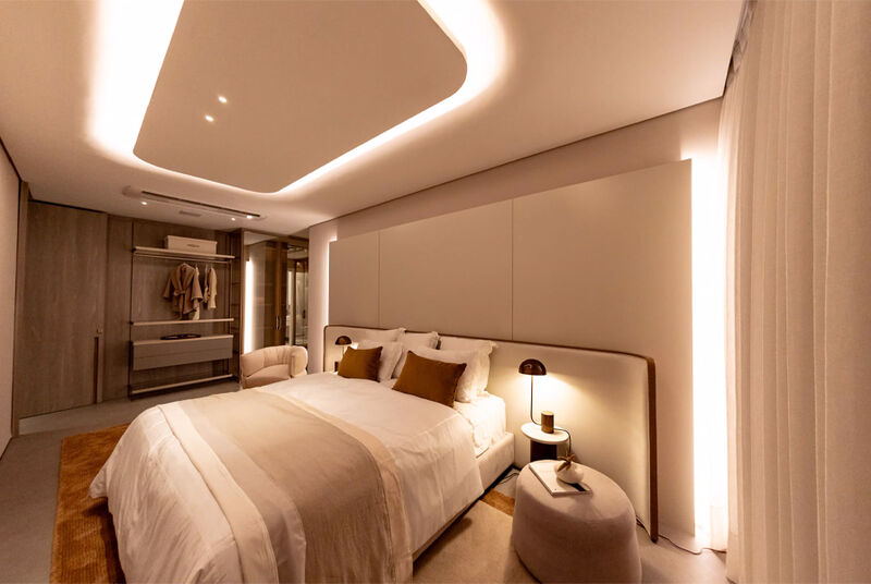 Quarto moderno com iluminação suave e cama aconchegante.