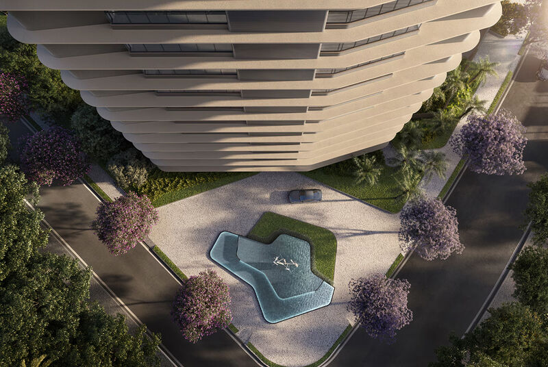 Vista aérea de um moderno edifício residencial com piscina.