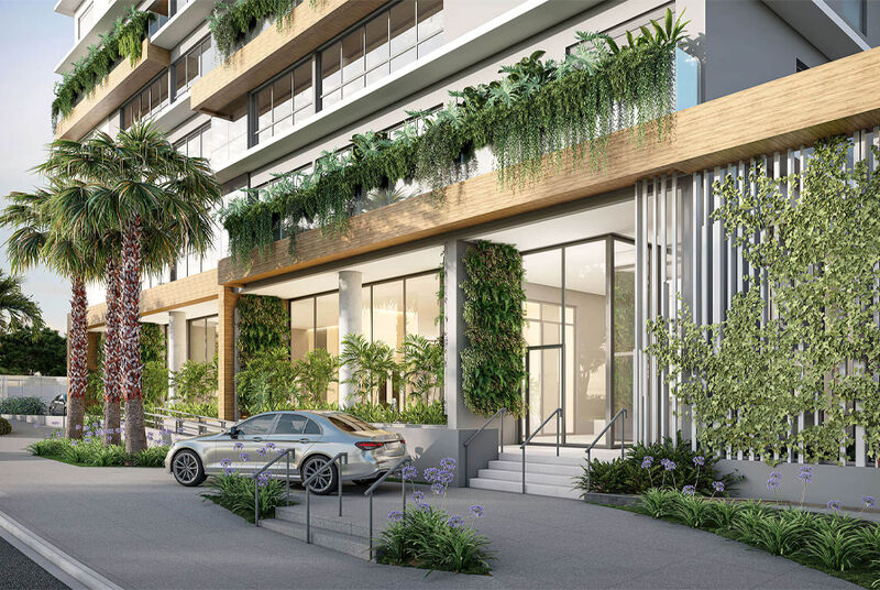 Entrada moderna de prédio com vegetação e carro
