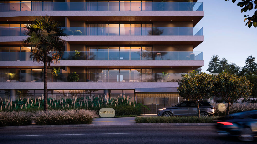 Edifício moderno com varandas e paisagismo na entrada